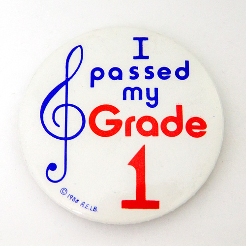 55mm I Passed My Grade 1 Badge - White Circular with Blue and Red Printing, Made in England